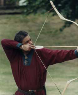 * An archer in a red tunic using a recurved box